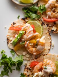 Close up of a sheet pan shrimp fajita with pepper, onion, and chipotle lime crema.