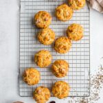 A dozen caraway Irish soda bread muffins, cooling and artfully arranged on a wire rack.