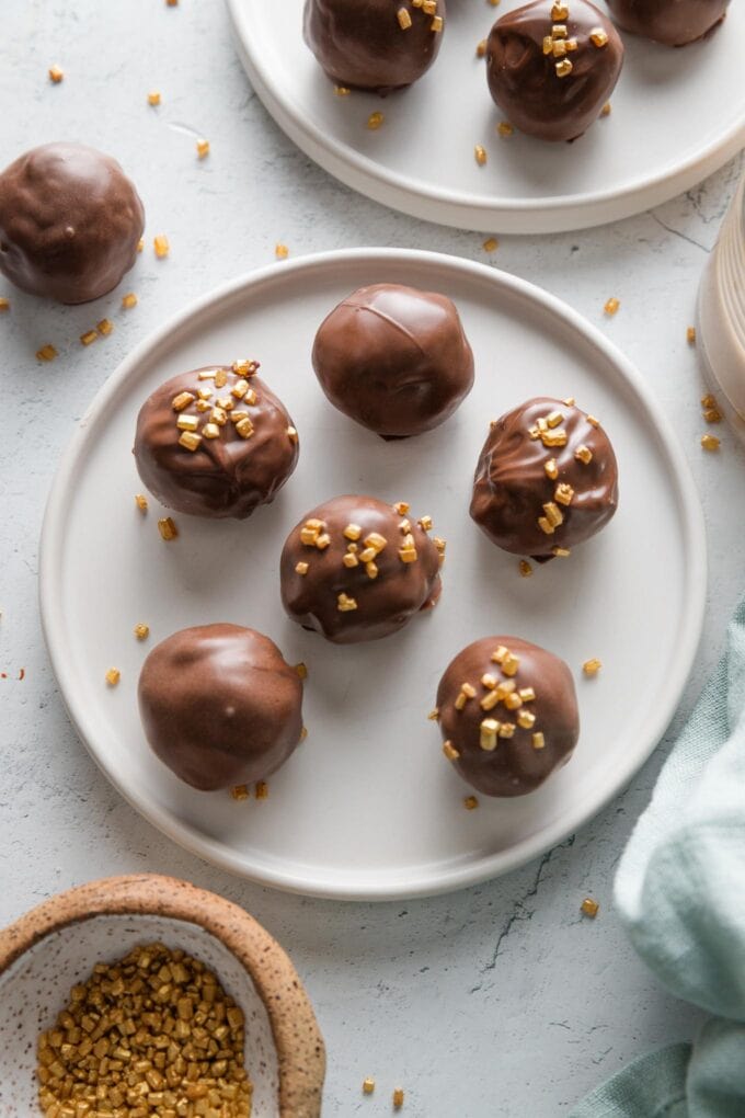 Plate of smooth, freshly-dipped and set Oreo truffles.