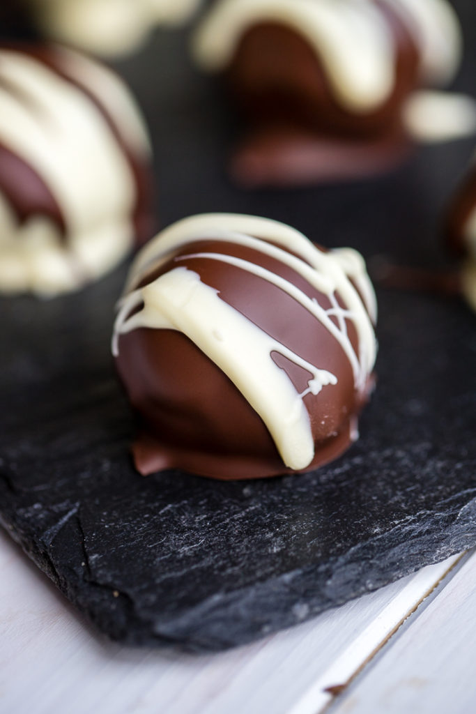 Close-up of a dark chocolate-coated Irish cream Oreo truffle.