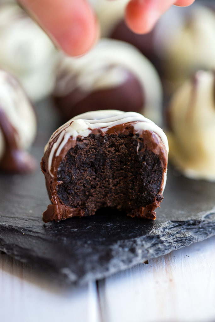 A toddler's fingers reaching to grab an Oreo truffle.