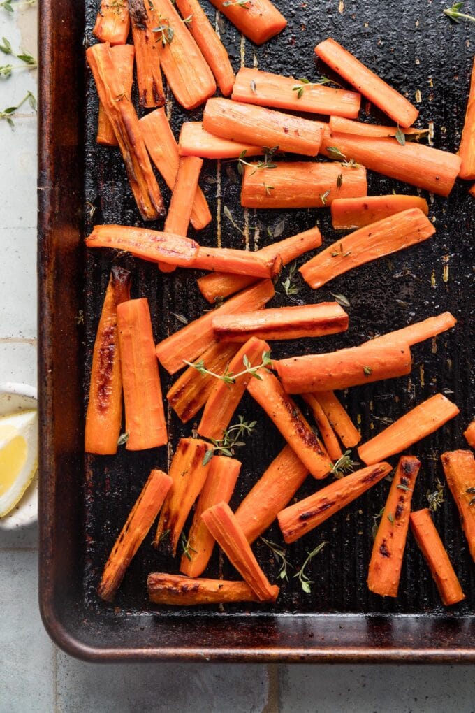 Roasted carrots with thyme are one of the simplest and yet most delicious side dishes I know. High heat brings out the natural sweetness of these veggies for a simple, healthy side that just may have people asking for seconds. I can happily even eat these as a snack.