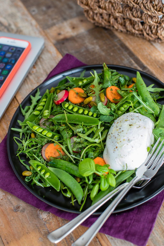 A working lunch with a healthy, fresh sugar snap pea salad with Buffalo mozzarella alongside a laptop and iPhone.