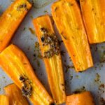 Thyme roasted carrots fresh from the oven, slightly browned, crinkly, and fork-tender.