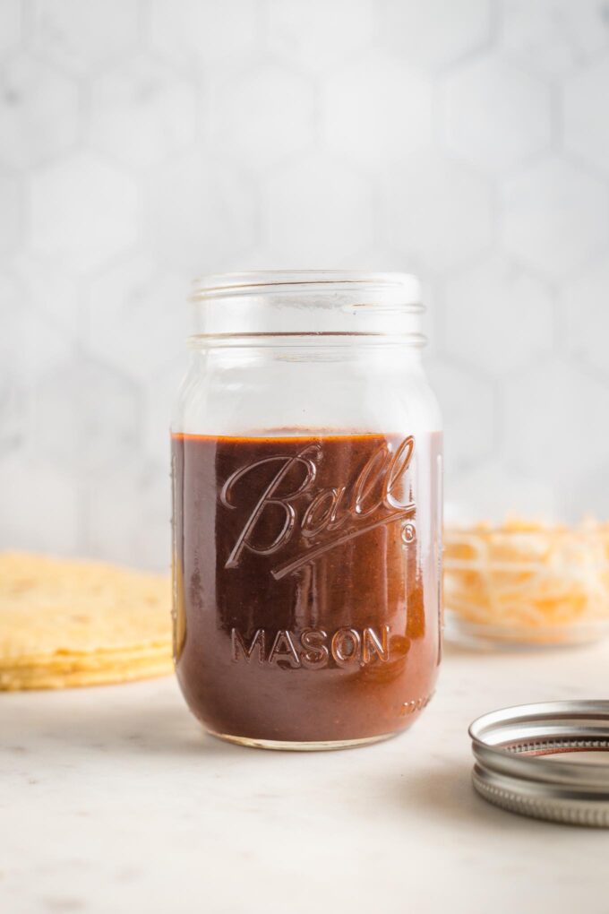 Mason jar filled with homemade red enchilada sauce.