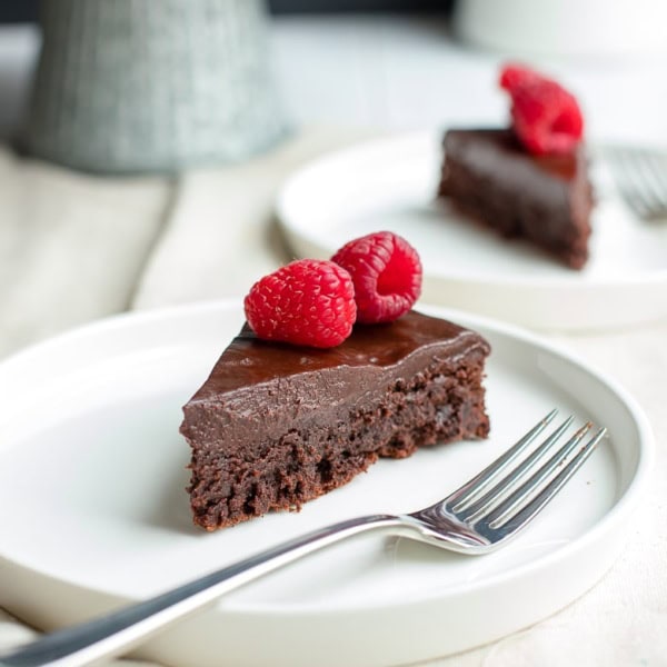 A fudgy, rich chocolate cake that is naturally gluten-free. Make this by hand in one bowl, then top with the easiest chocolate ganache (just chocolate and cream!) and fresh fruit for an impressive party dessert!