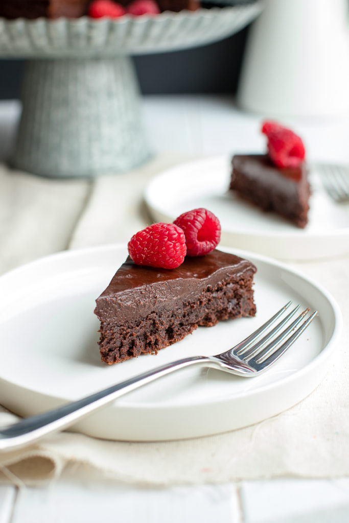 A fudgy, rich chocolate cake that is naturally gluten-free. Make this by hand in one bowl, then top with the easiest chocolate ganache (just chocolate and cream!) and fresh fruit for an impressive party dessert!