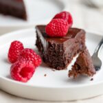 A fudgy, rich chocolate cake that is naturally gluten-free. Make this by hand in one bowl, then top with the easiest chocolate ganache (just chocolate and cream!) and fresh fruit for an impressive party dessert!