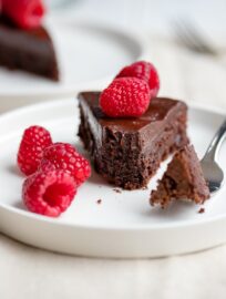 A fudgy, rich chocolate cake that is naturally gluten-free. Make this by hand in one bowl, then top with the easiest chocolate ganache (just chocolate and cream!) and fresh fruit for an impressive party dessert!