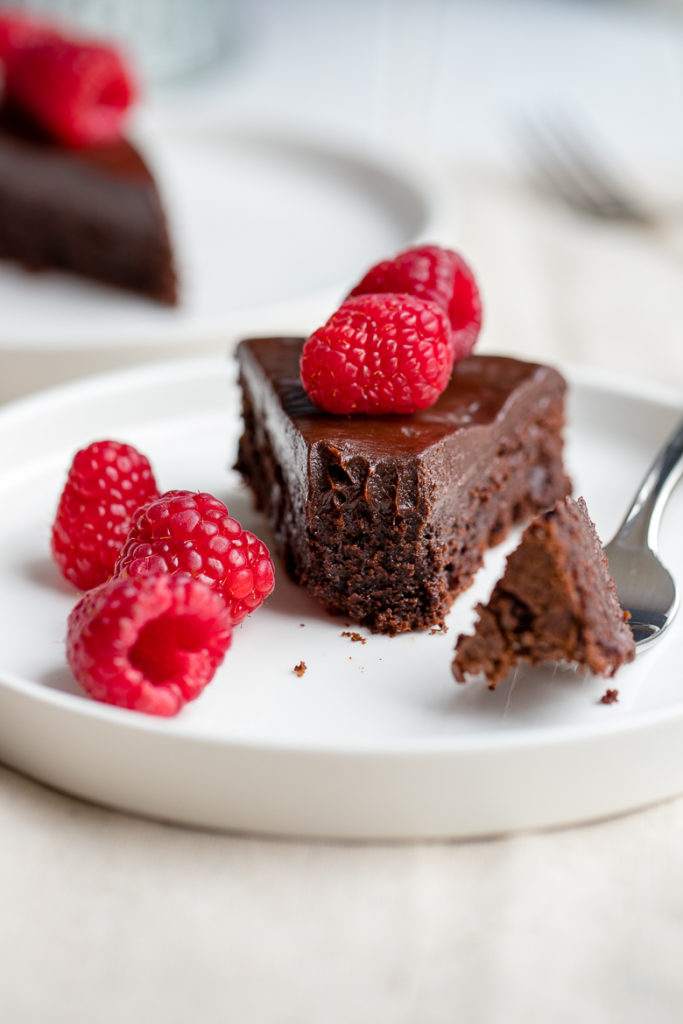 A fudgy, rich chocolate cake that is naturally gluten-free. Make this by hand in one bowl, then top with the easiest chocolate ganache (just chocolate and cream!) and fresh fruit for an impressive party dessert!