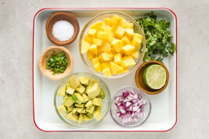 Cut mango, avocado, jalapeno, red onion, cilantro, lime, and salt in prep bowls.