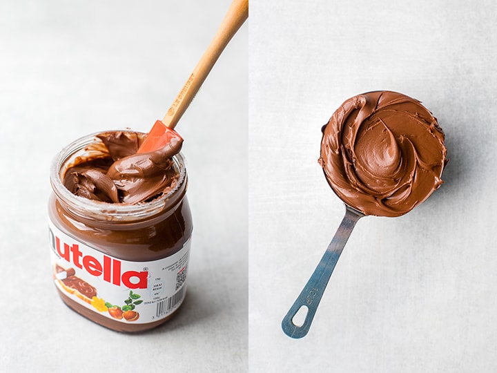 An open jar of Nutella and a large measuring cup filled with the chocolate hazelnut spread.
