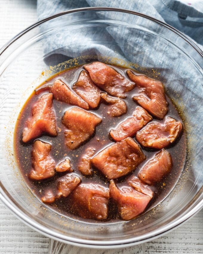 A prep bowl with cubes of pork swimming in marinade.