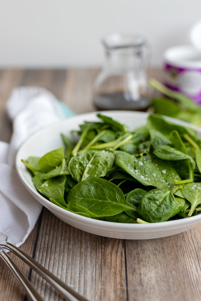 Baby spinach leaves washed and sprinkled with coarse sea salt.