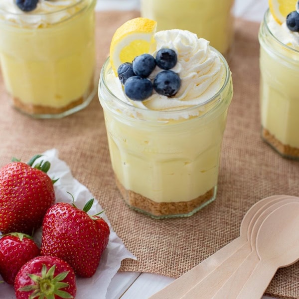 Jam jars filled with no-bake lemon cheesecake mousse.