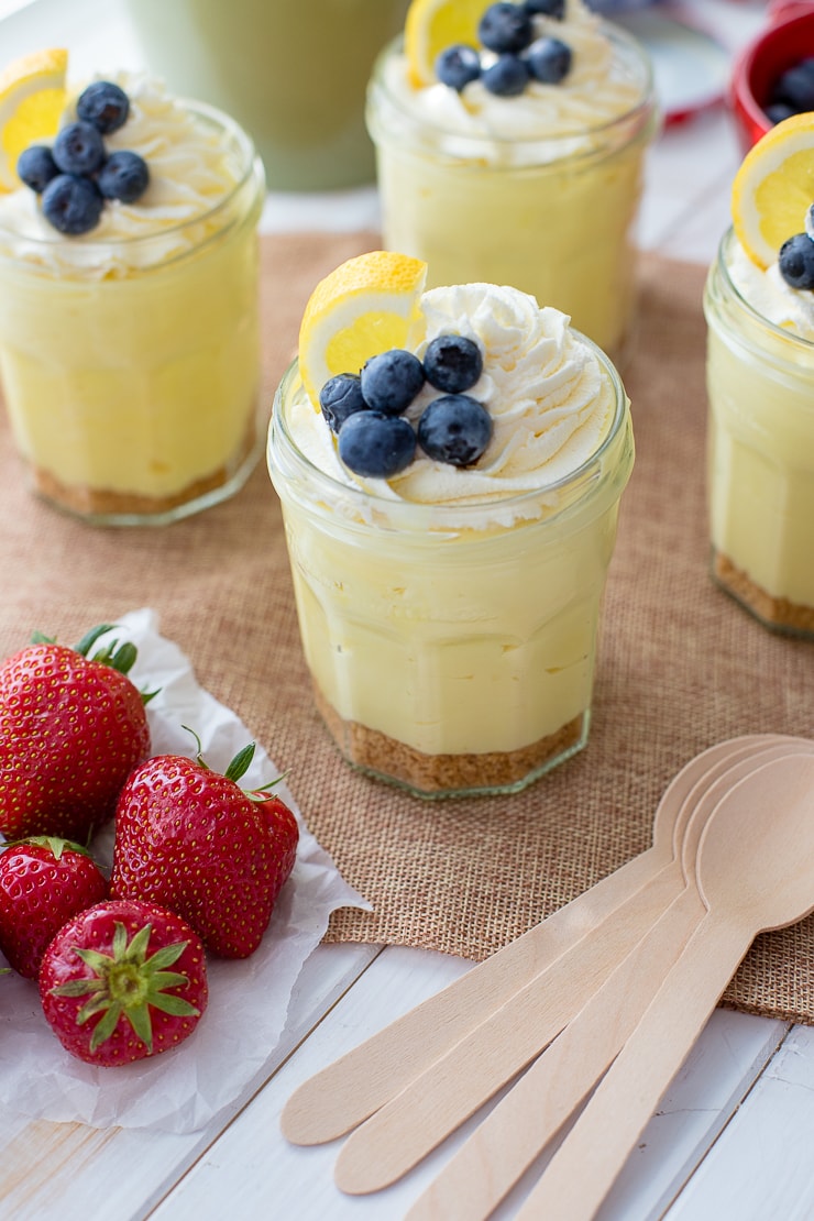 Jam jars filled with no-bake lemon cheesecake mousse.