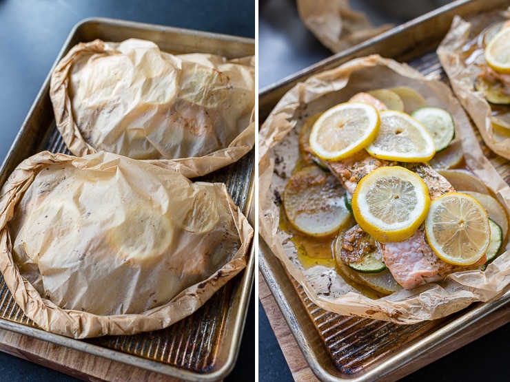 Two servings of salmon folded up in parchment packets.