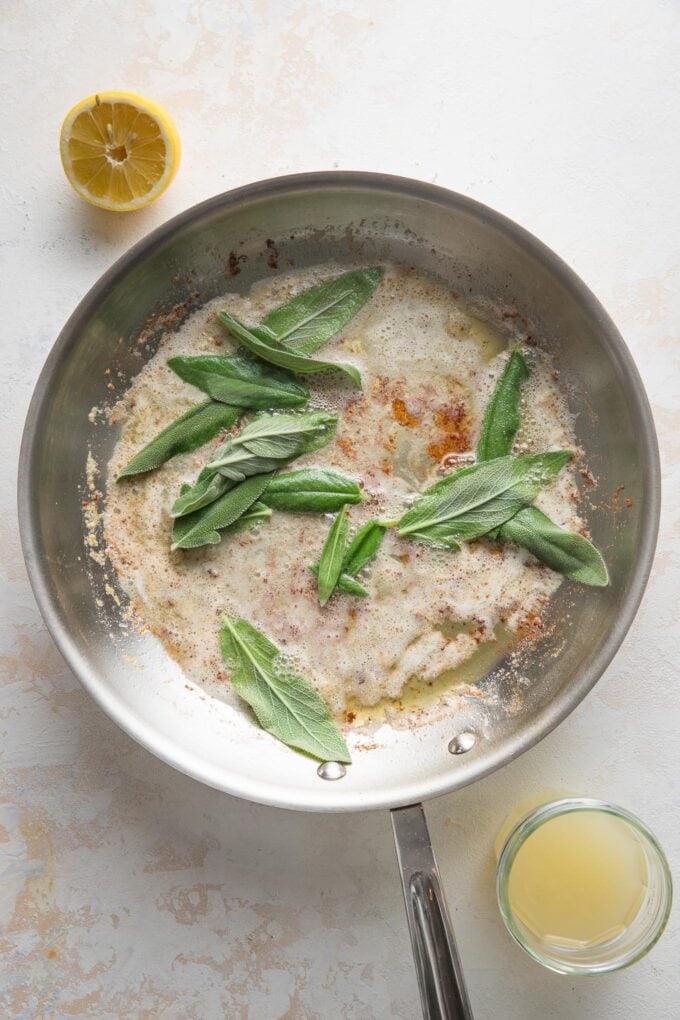 Sage leaves added to a pan with butter.