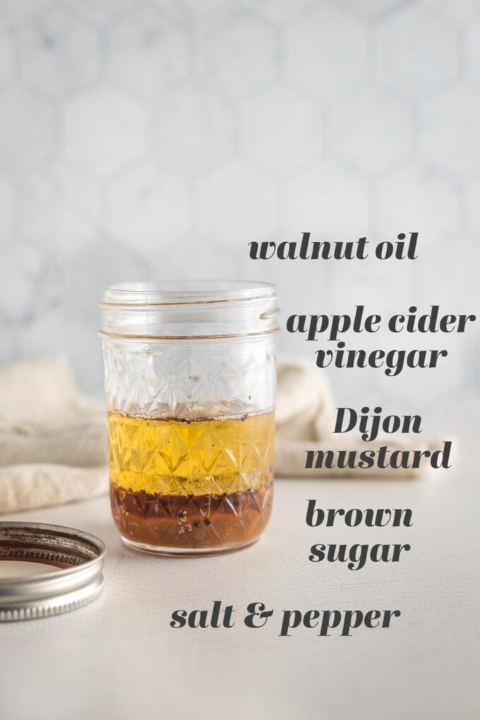 Small jar with the ingredients for an apple cider vinaigrette.