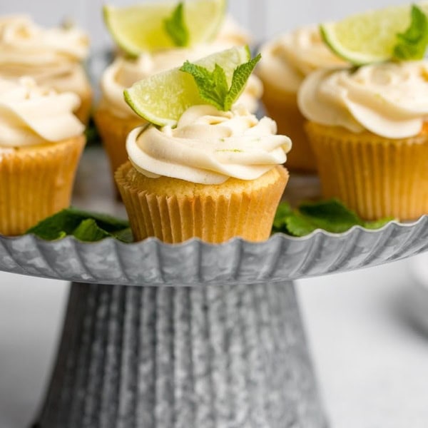 Spread of mojito cupcakes on a galvanized cake stand.
