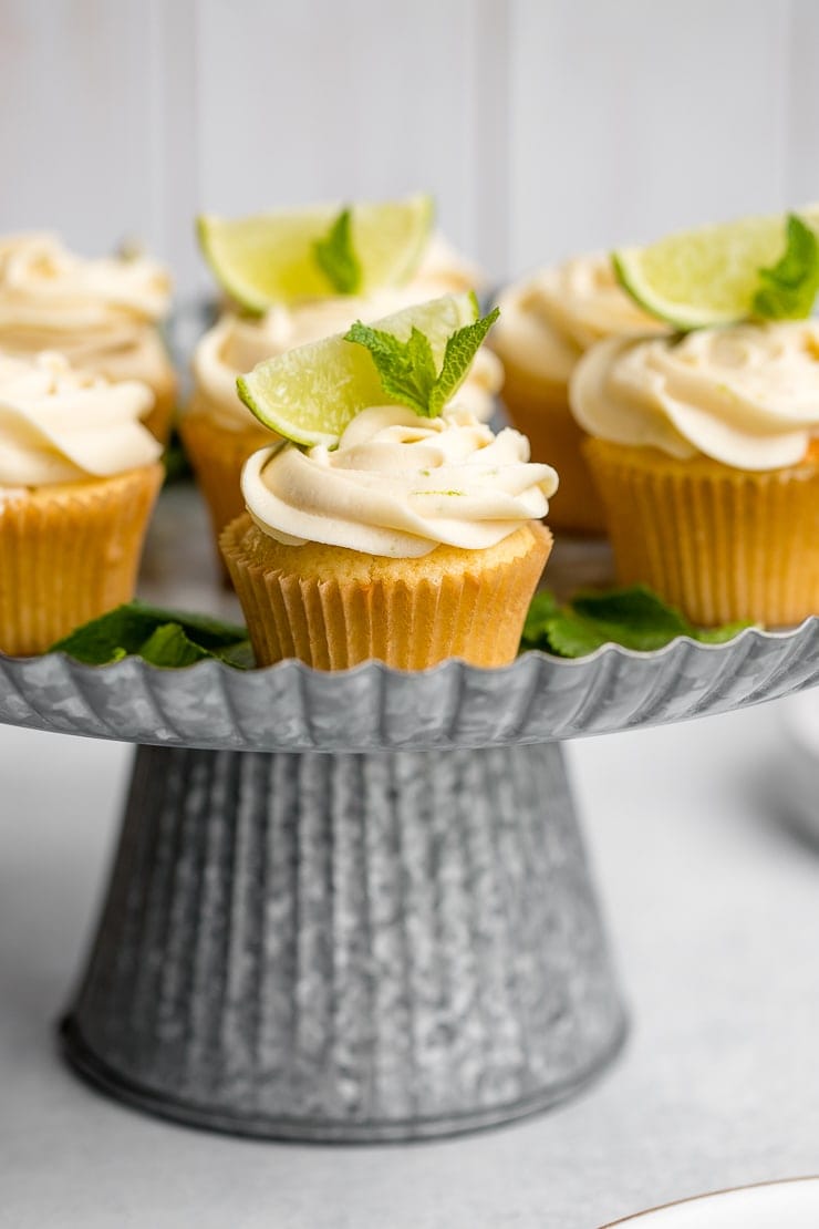 Spread of mojito cupcakes on a galvanized cake stand.