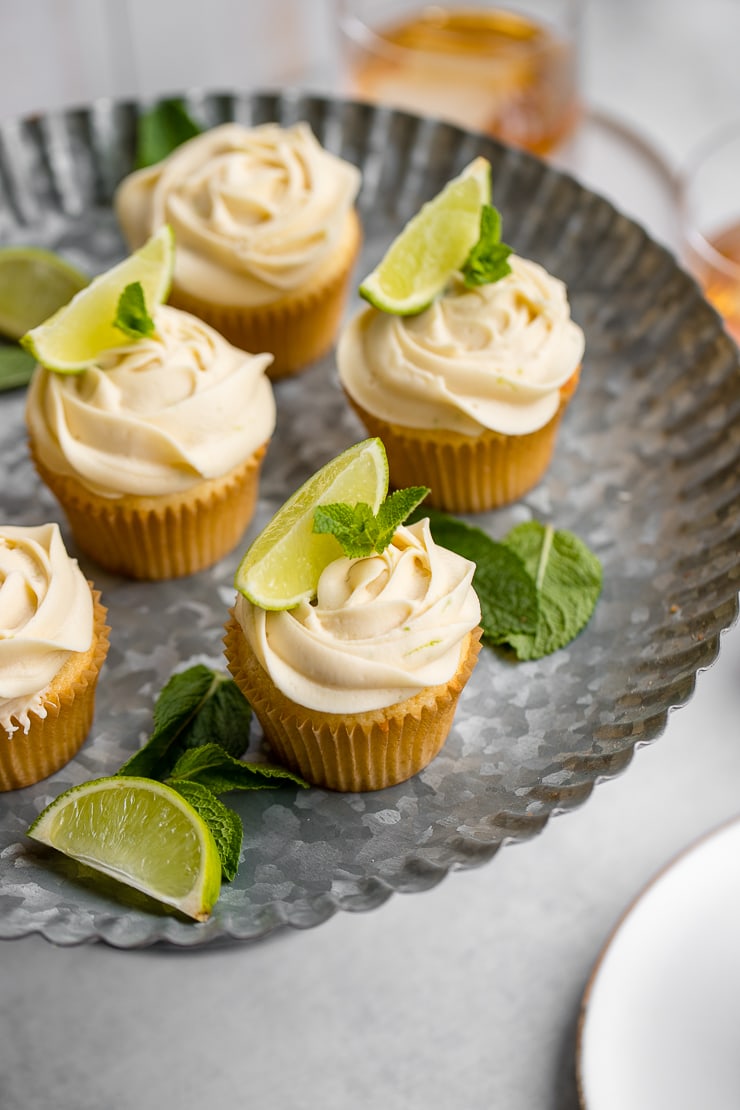 Spread of mojito cupcakes on a galvanized cake stand.