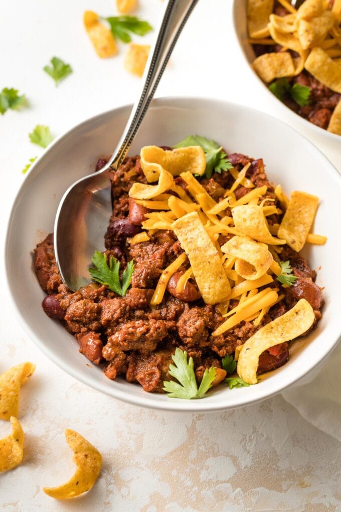 Bowl of chili with a spoon, ready to eat.