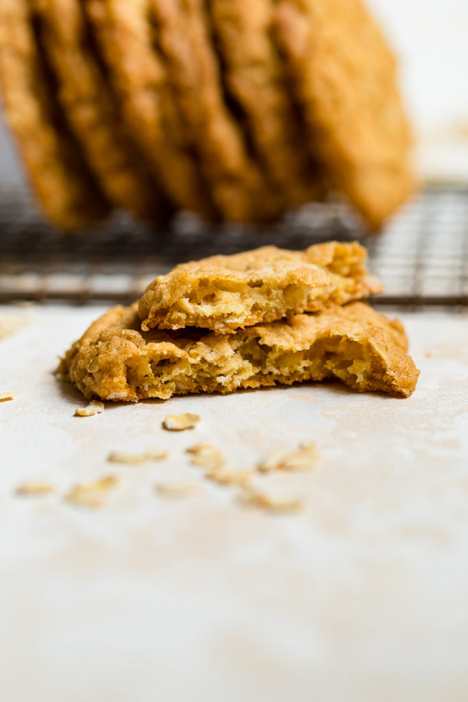 A crisp oatmeal cookie broken in half.