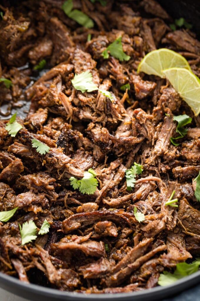 Close-up of shredded barbacoa in a skillet.