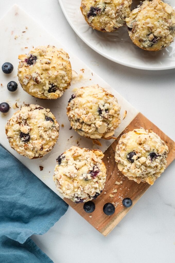 Blueberry almond muffins served on a small white tray.
