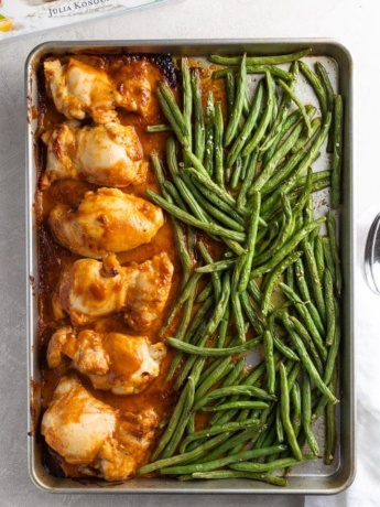Easy chicken thighs in peanut sauce with green beans, on a sheet pan just out of the oven.