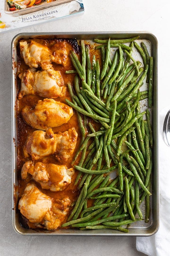 Easy chicken thighs in peanut sauce with green beans, on a sheet pan just out of the oven.