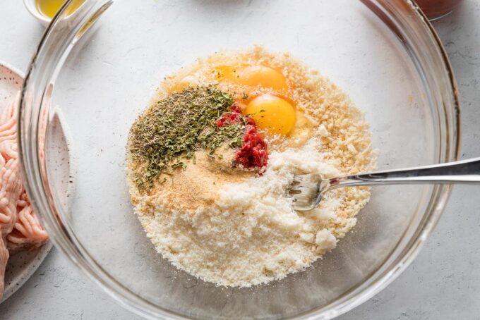 Meatball base--except for the meat--combined in a clear glass prep bowl.