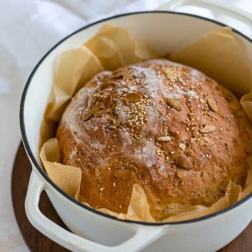 https://www.nourish-and-fete.com/wp-content/uploads/2018/12/no-knead-dutch-oven-bread-with-seeds-720px-4-500x500.jpg