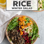 The most delicious healthy salad! A hearty wild rice winter salad uses seasonal greens and pomegranates for a filling and fresh side that is easy to throw together. #wildrice #salad #healthyrecipes