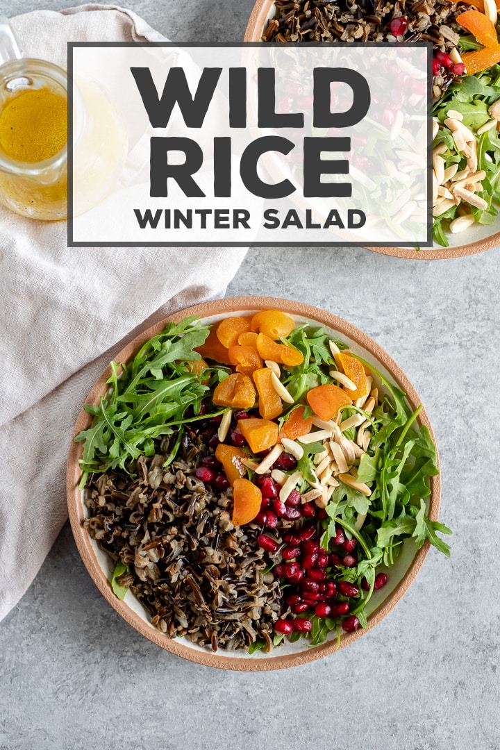 The most delicious healthy salad! A hearty wild rice winter salad uses seasonal greens and pomegranates for a filling and fresh side that is easy to throw together. #wildrice #salad #healthyrecipes