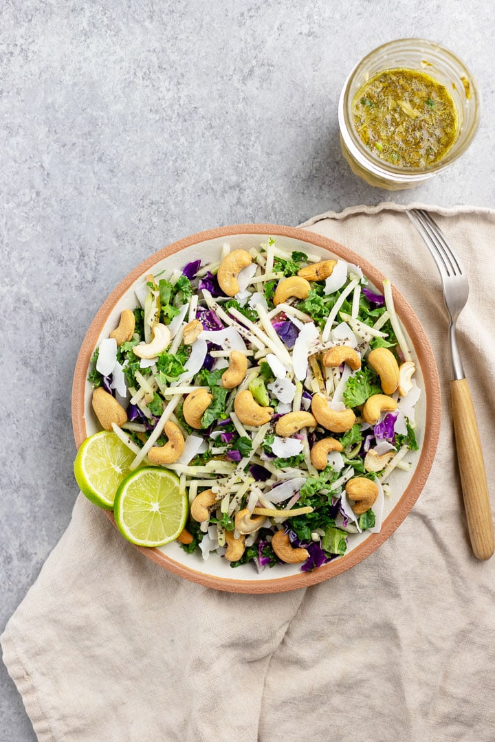 Close-up of a bowl holding cashew coconut slaw with cilantro-lime vinaigrette, made using a Mann's Veggie Blend.