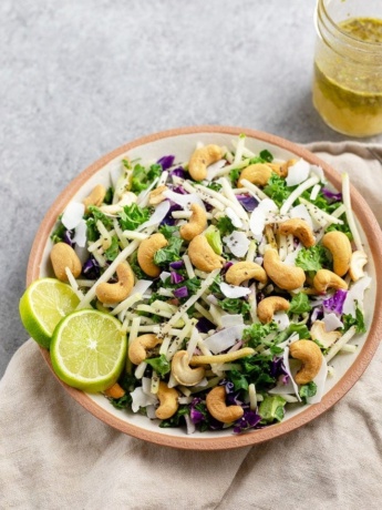 Close-up of a bowl holding cashew coconut slaw with cilantro-lime vinaigrette, made using a Mann's Veggie Blend.