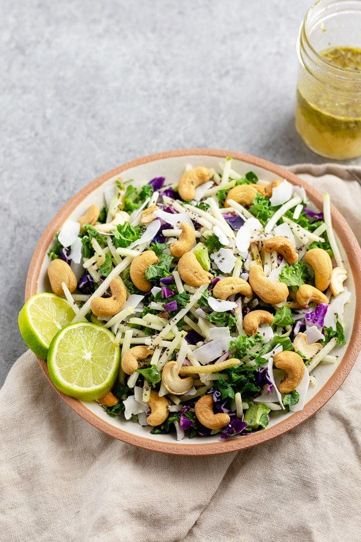 Close-up of a bowl holding cashew coconut slaw with cilantro-lime vinaigrette, made using a Mann's Veggie Blend.