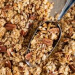 Baking tray filled with coconut pecan granola.