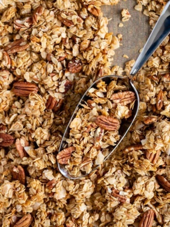 Baking tray filled with coconut pecan granola.
