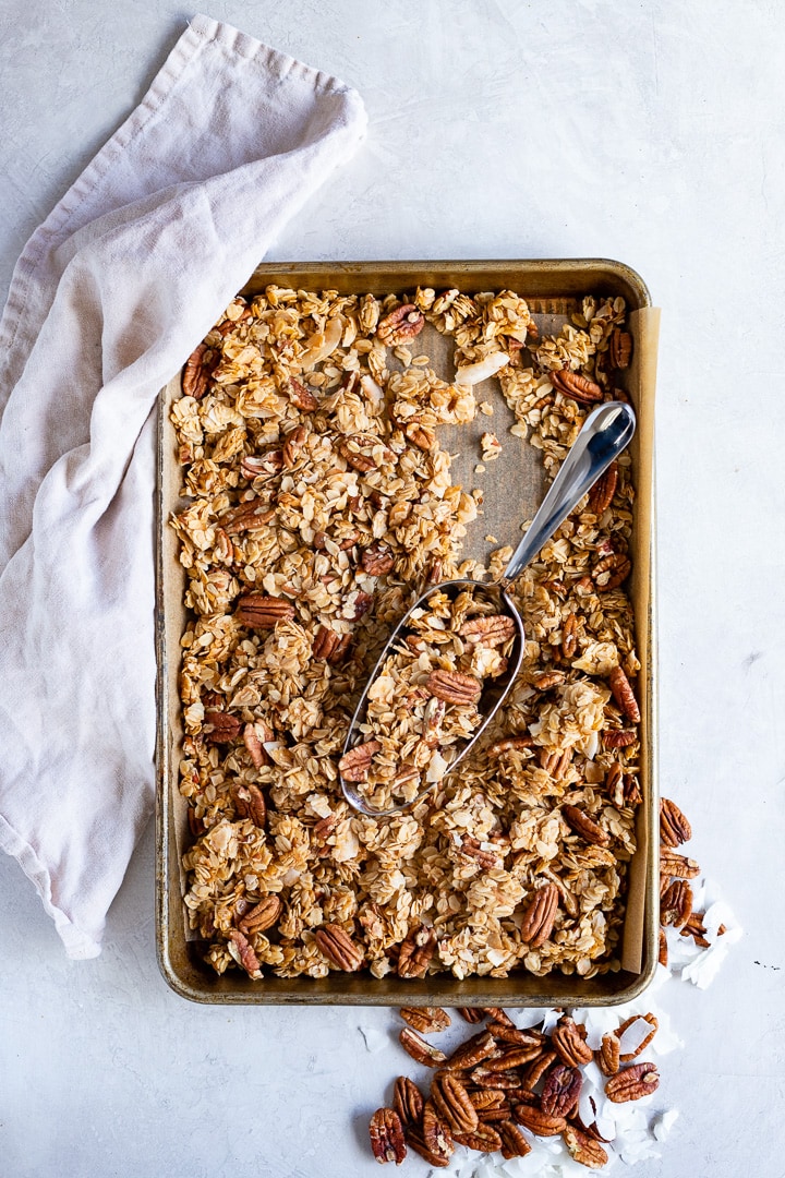 Baking tray filled with coconut pecan granola.