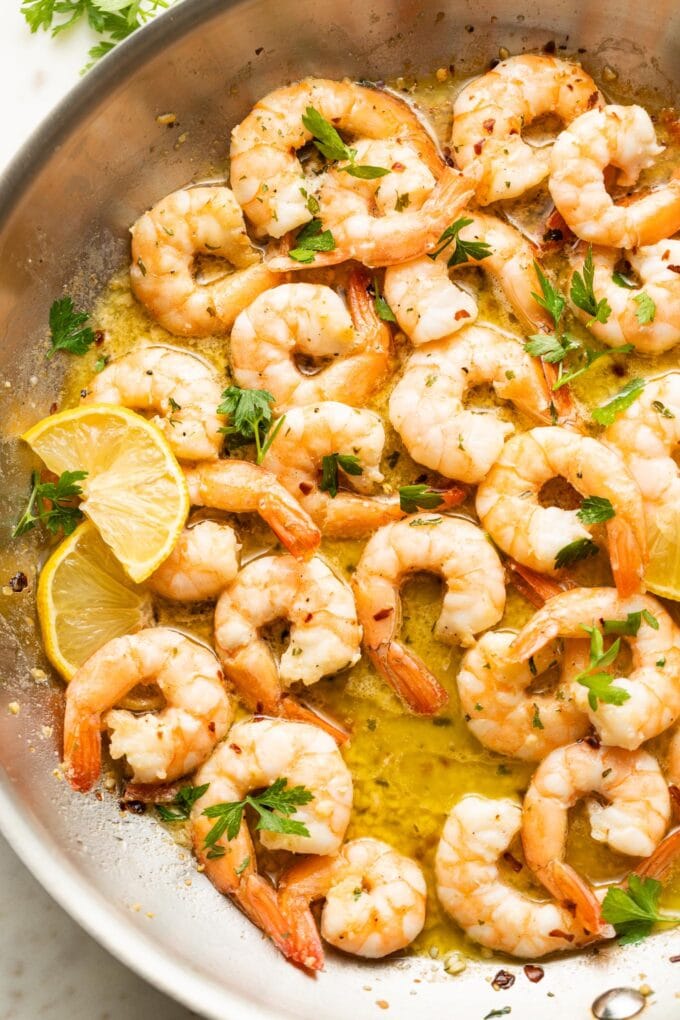 Garlic butter shrimp cooked in a skillet.