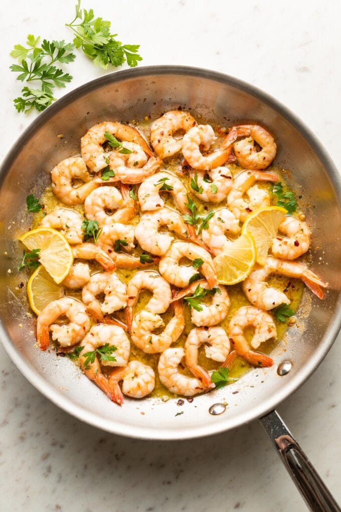 Garlic butter shrimp cooked in a skillet.