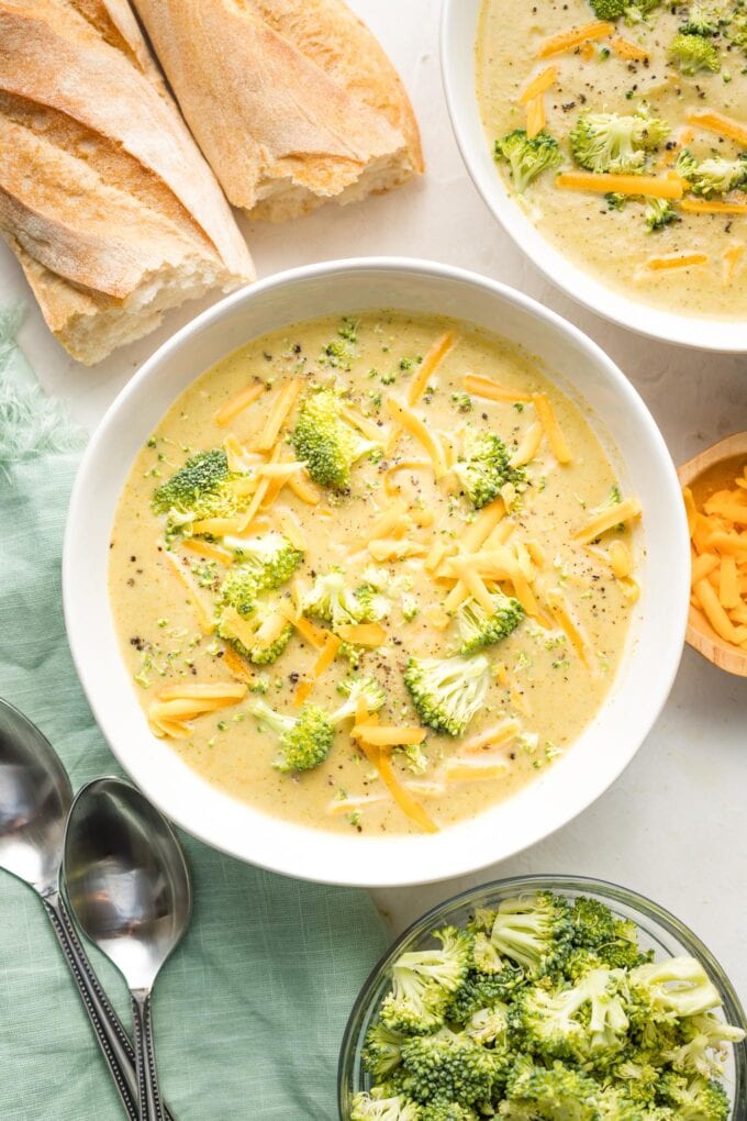 Overhead image of broccoli cheddar soup in a white bowl.