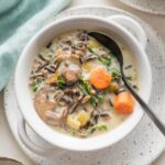 Small soup bowl filled with a creamy Instant Pot wild rice soup.