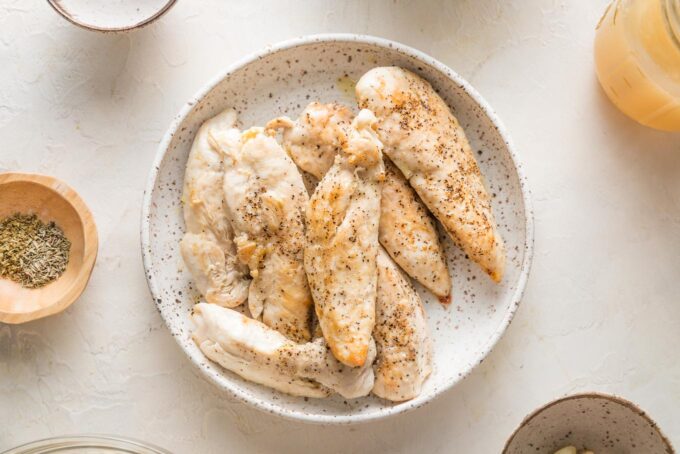 Cooked chicken tenders in a bowl.