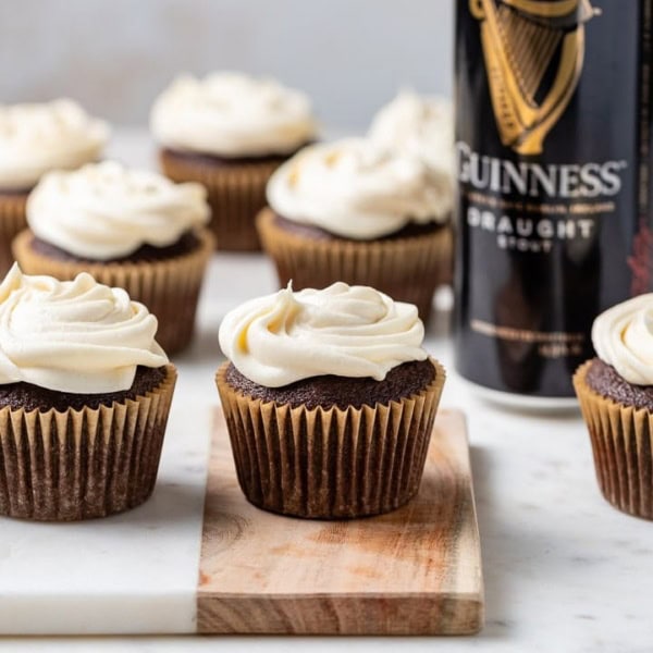 Chocolate Guinness cupcakes with Irish cream frosting arranged on a board.