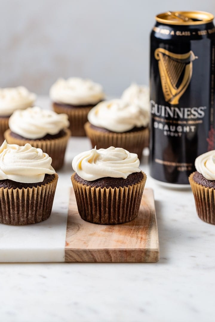 Chocolate Guinness cupcakes with Irish cream frosting arranged on a board.