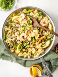 Skillet with lemon asparagus pasta with shrimp and pistachios.